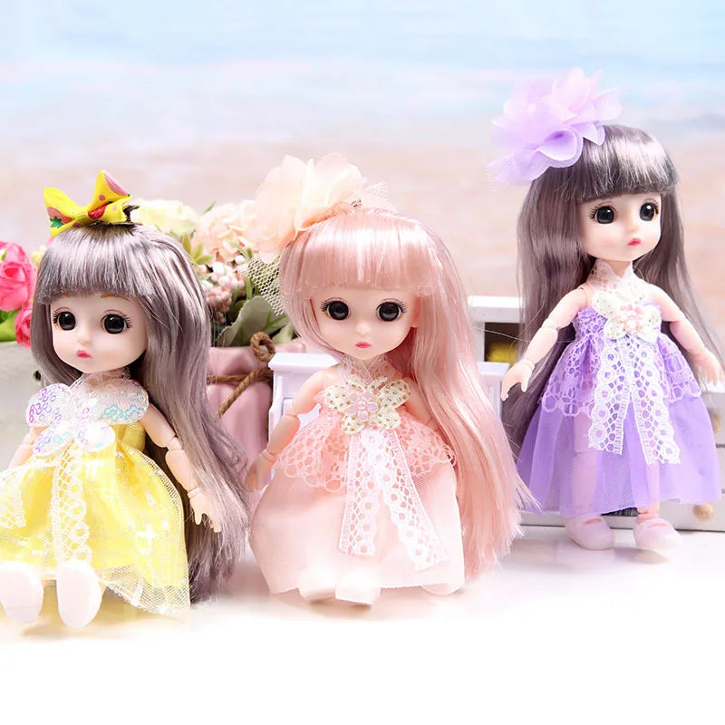 A collection of three 17cm articulated princess dolls with various pink and purple dresses and floral hair accessories.