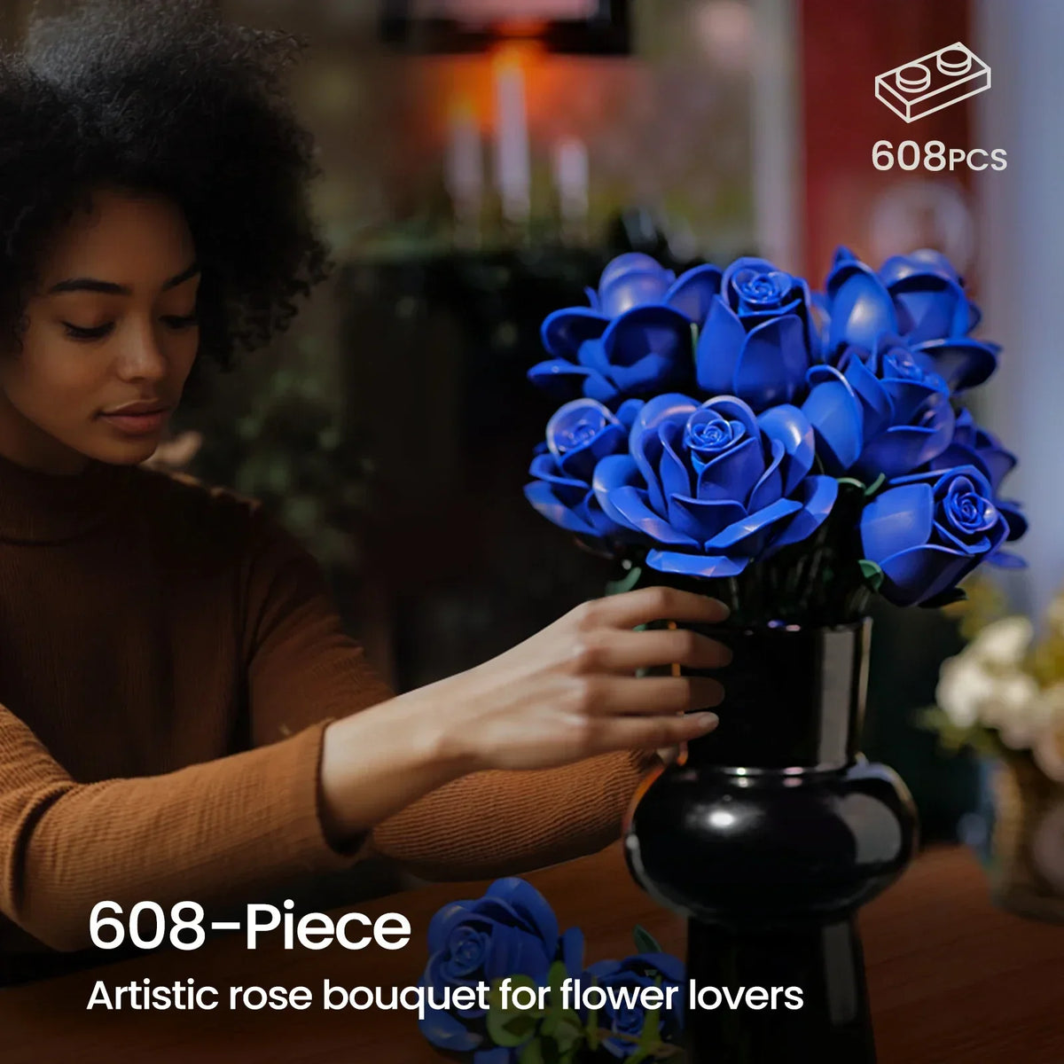 A woman holds a bouquet of realistic blue roses made from 608 building blocks.