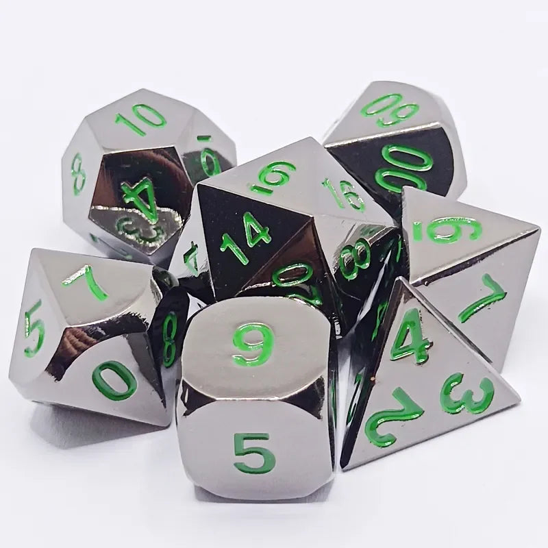 A set of polyhedral dice in a silver metal finish with green markings, including a d10, d20, and d30.