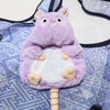 A purple Moo Deng Pygmy Hippo plush toy with large ears and a white belly is shown against a patterned fabric background.