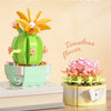 A set of building blocks forming a flower bouquet, featuring green and pink elements.