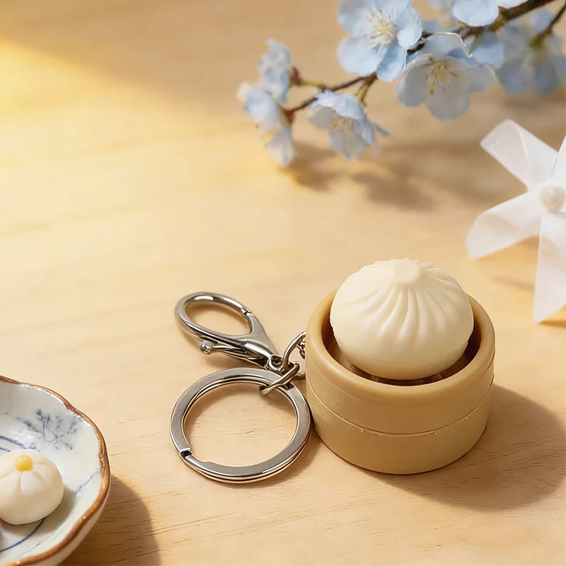 A beige fidget keychain featuring a smooth, round white toy inside a wooden holder, set against a light wood background with 