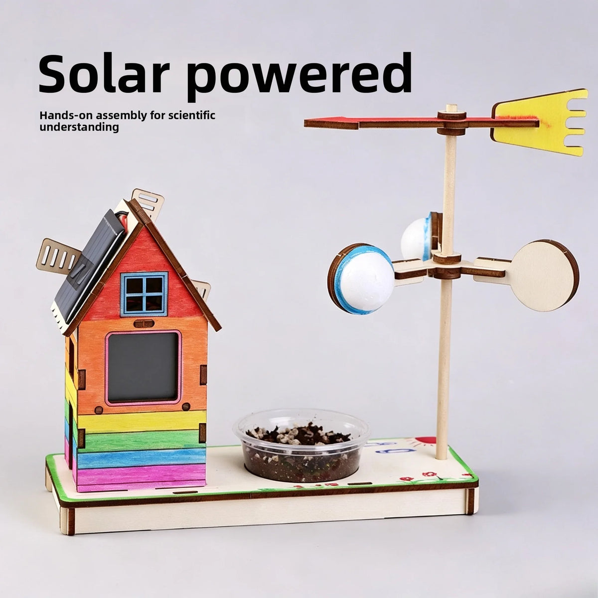 Hands-on assembly kit for a solar-powered lunar rover model featuring a wooden house structure and solar panels.