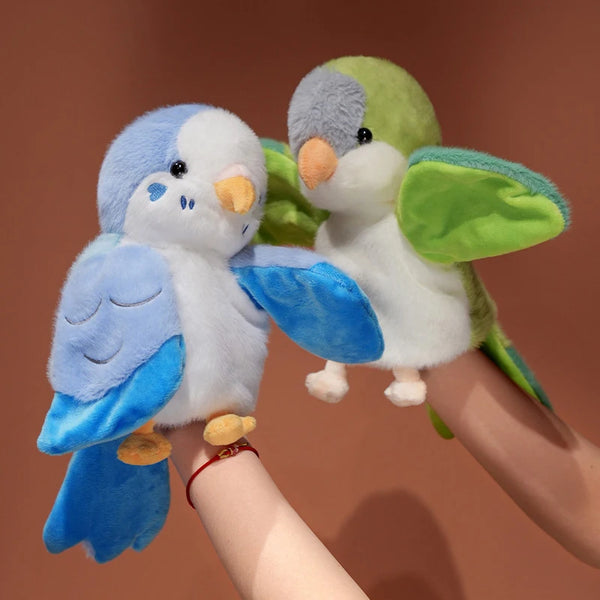 A pair of cute parrot plush finger puppets featuring blue and green feathers being held by a person's hand.