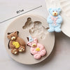 A set of silicone baby-themed cake molds including a teddy bear, a pink unicorn, and a blue bear.