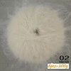 A spherical ball of light beige long-haired alpaca blend yarn used for knitting.