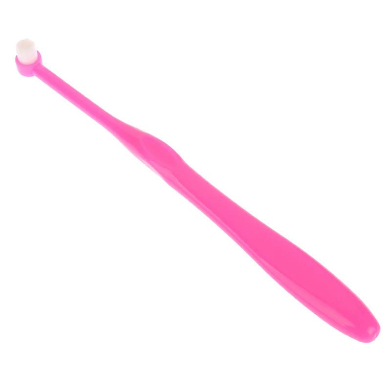 A bright pink orthodontic interdental brush with a soft bristle tip.