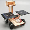 A wooden model kit of a solar-powered lunar rover featuring large solar panels and wheels.