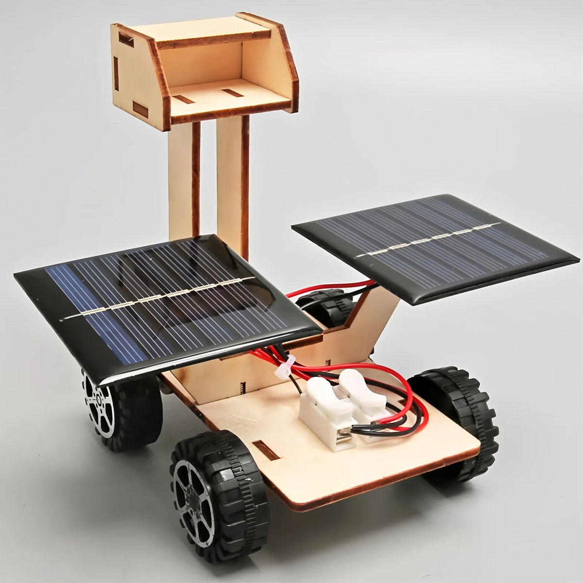 A wooden model kit of a solar-powered lunar rover featuring large solar panels and wheels.
