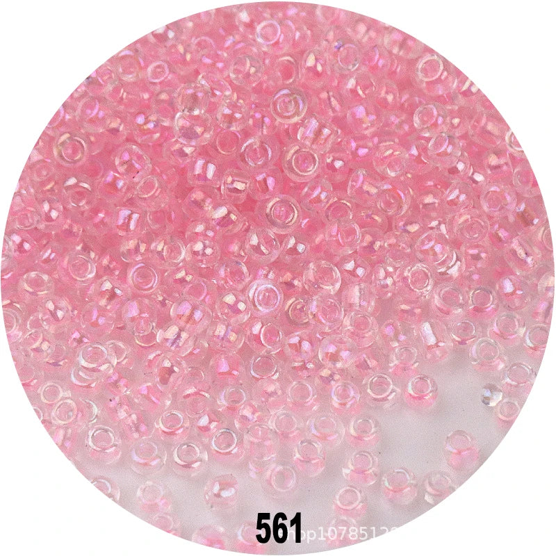 A microscopic view of pink glass seed beads used for jewelry making