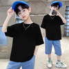 A young male model wearing a black classic cotton crew neck t-shirt and blue baseball cap standing indoors.