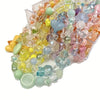 A collection of mixed colored acrylic loose beads in various shapes and sizes for jewelry making