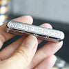 A hand holds a silver metal fidget slider labeled Deep-Fried Dough Sticks.