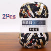 A ball of black and beige patterned soft chunky t-shirt yarn for crochet and knitting, packaged as a 2-pack.