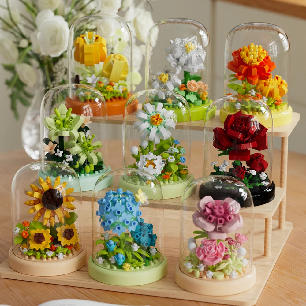 A collection of clear glass molds filled with colorful floral building blocks and accessories.