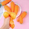 A hand is holding and arranging bright orange carrot squishy stress relief toys on a pink plate.