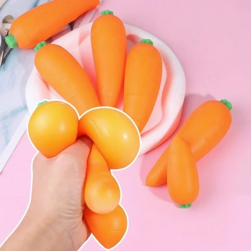 A hand is holding and arranging bright orange carrot squishy stress relief toys on a pink plate.