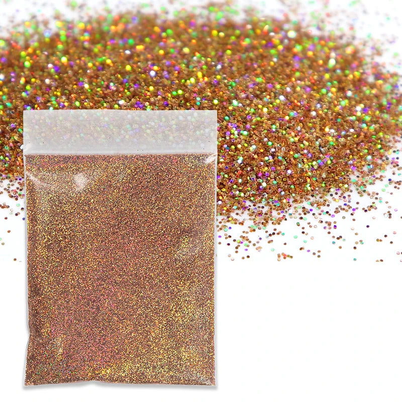 A small plastic bag filled with holographic fine glitter powder scattered across the surface.