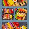 A colorful set of mini barbecue food items including sausages, hot dogs, and various meats on wooden sticks.