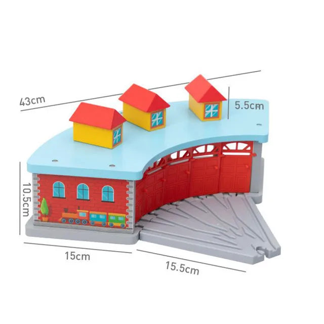 A wooden train track accessory set featuring airport and gas station scenes with red and yellow buildings.