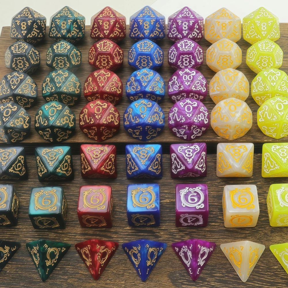 A collection of dragon-inspired polyhedral dice in various colors and shapes for tabletop role-playing games