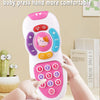 A hand is pressing a pink silicone button on a white remote control toy with various colored buttons and lights.