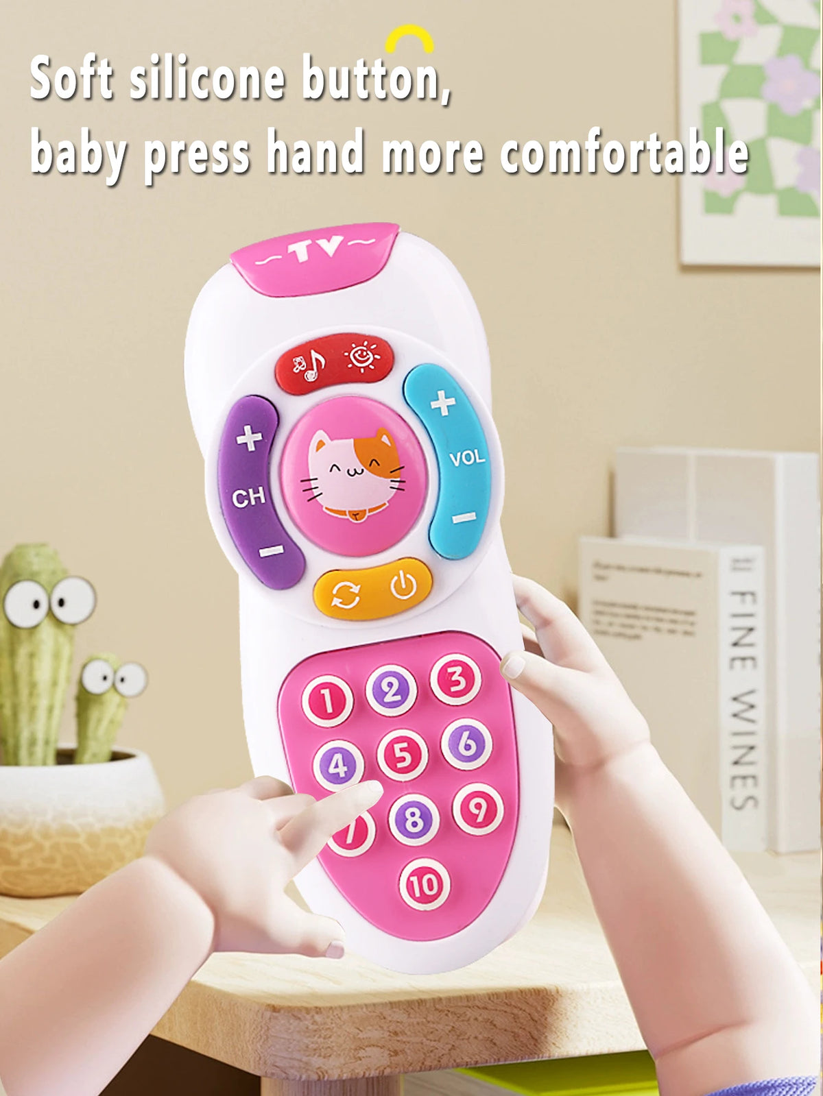 A hand is pressing a pink silicone button on a white remote control toy with various colored buttons and lights.