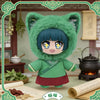 A plush blind box of a green cat-eared character wearing a green outfit in an apothecary setting.
