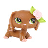 A brown miniature pet animal figure with pink accents and a light green rose accessory.