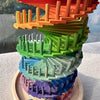 A colorful sensory music tree marble run featuring stacked wooden ramps and colored marbles.