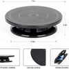 A black cake decorating kit featuring a rotating turntable, spatulas, and scrapers made of PP plastic material.