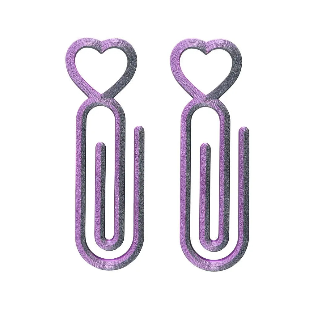 A pair of purple heart-shaped canvas clips for diamond painting and cross stitch.