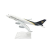 A white diecast model of a Boeing airplane with UPS branding on the tail, displayed on a clear stand.