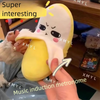 A hand is holding a yellow, fruit-shaped plush toy with a mouth opening, demonstrating its music induction function.