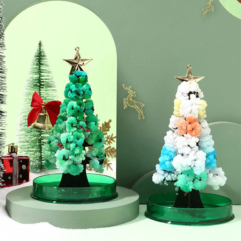 A festive crystal growing tree decoration featuring green and white crystals on a dark base.