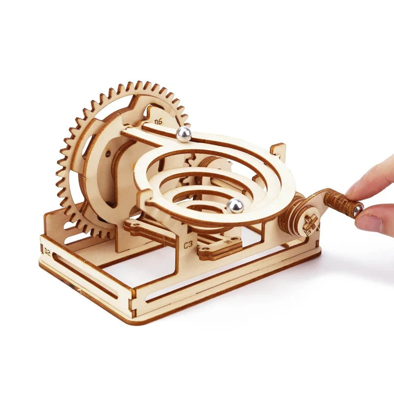 A wooden spiral marble run DIY puzzle kit featuring gears and a track for marble movement.