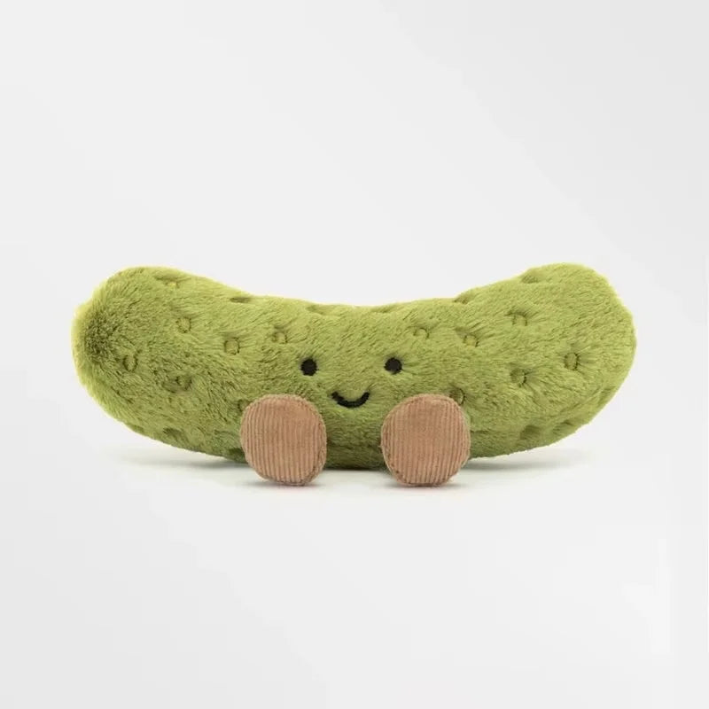 A soft, light green plush pickle toy with a smiling face.