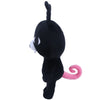 A black plush stuffed animal resembling a bunny with white accents and a pink curled tail.