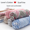 A collection of pink, gray, and blue lover's cotton yarn skeins for knitting or crafting.