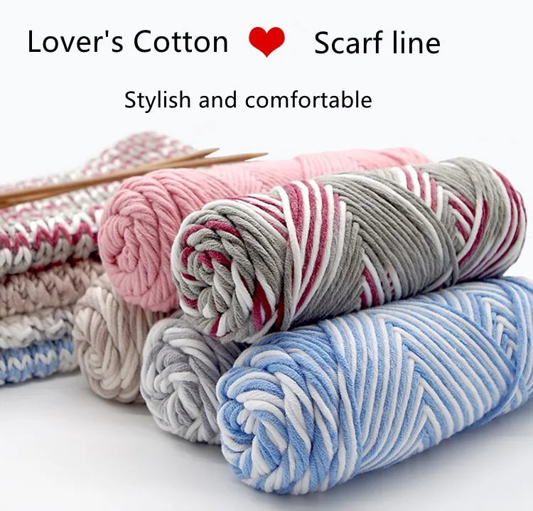 A collection of pink, gray, and blue lover's cotton yarn skeins for knitting or crafting.