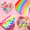 Colorful origami star paper strips in various colors arranged in heart shapes and strips.