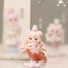 A delicate pink collectible figurine of a girl with white hair and a small bird on her head.