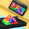 A black plastic case holds numerous colorful pyramid beads arranged in various patterns for a logic puzzle.
