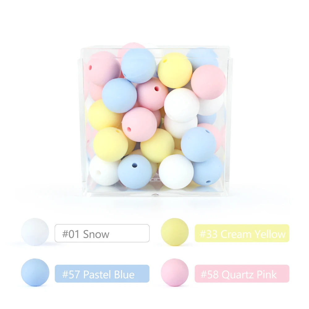 A clear container filled with various soft silicone beads in pastel colors including pink, yellow, blue, and white.