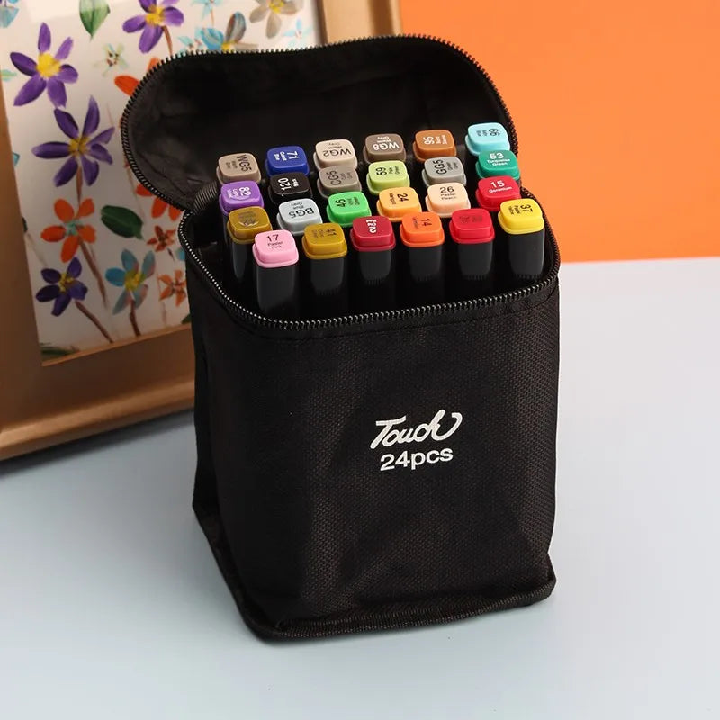 A black pouch containing 24 alcohol art markers with various colors and tips, resting on a light surface.