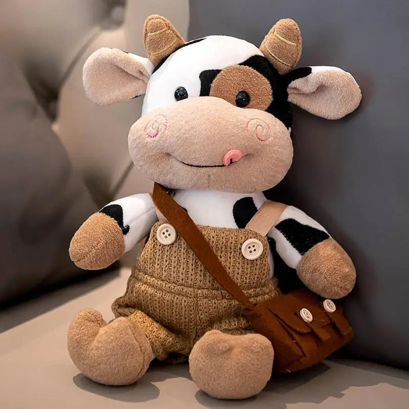 A soft stuffed animal of a cow with black and white markings wearing a brown vest and carrying a small bag.