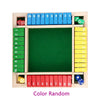 A wooden game board with colored dice and numbered slots for a four-player dice game
