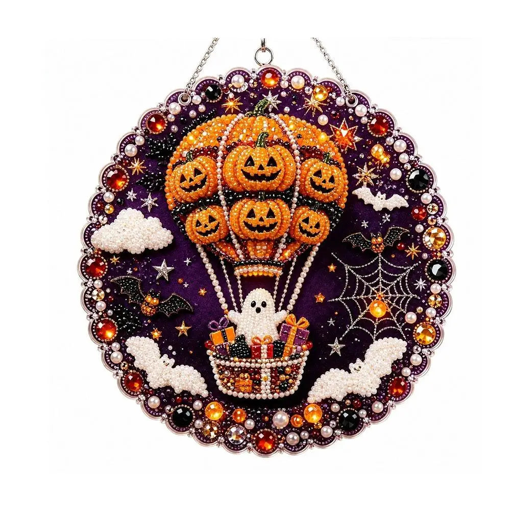 A detailed diamond painting hanging ornament kit featuring an orange pumpkin hot air balloon with bats and spiders on a purpl