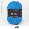 A ball of bright blue milk cotton yarn labeled with Chinese characters and a thread count of 71