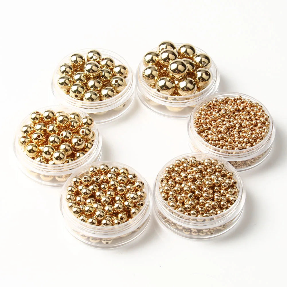 A collection of round gold spacer beads arranged in a circular pattern.